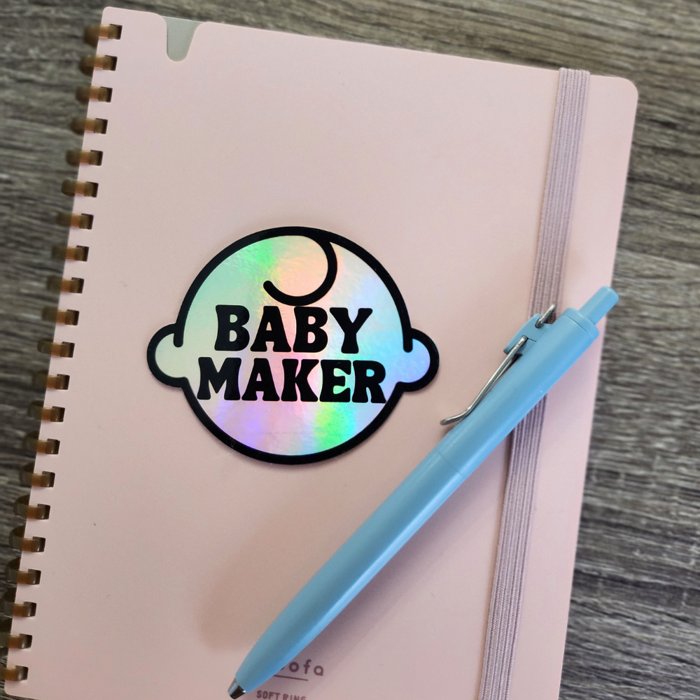 Baby Maker Holographic Vinyl Sticker Shown on Notebook