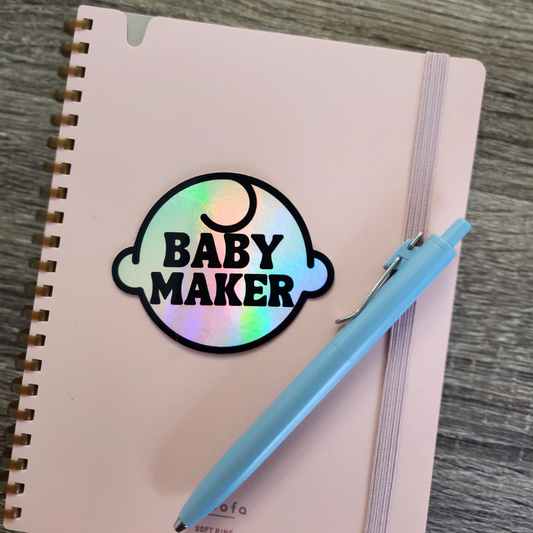 Baby Maker Holographic Vinyl Sticker Shown on Notebook