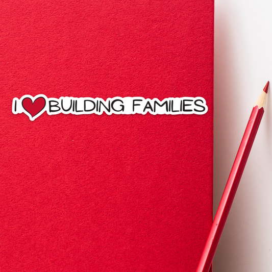 I ❤ Building Families Vinyl 5.47” x .75” Sticker Shown in Context on Notebook
